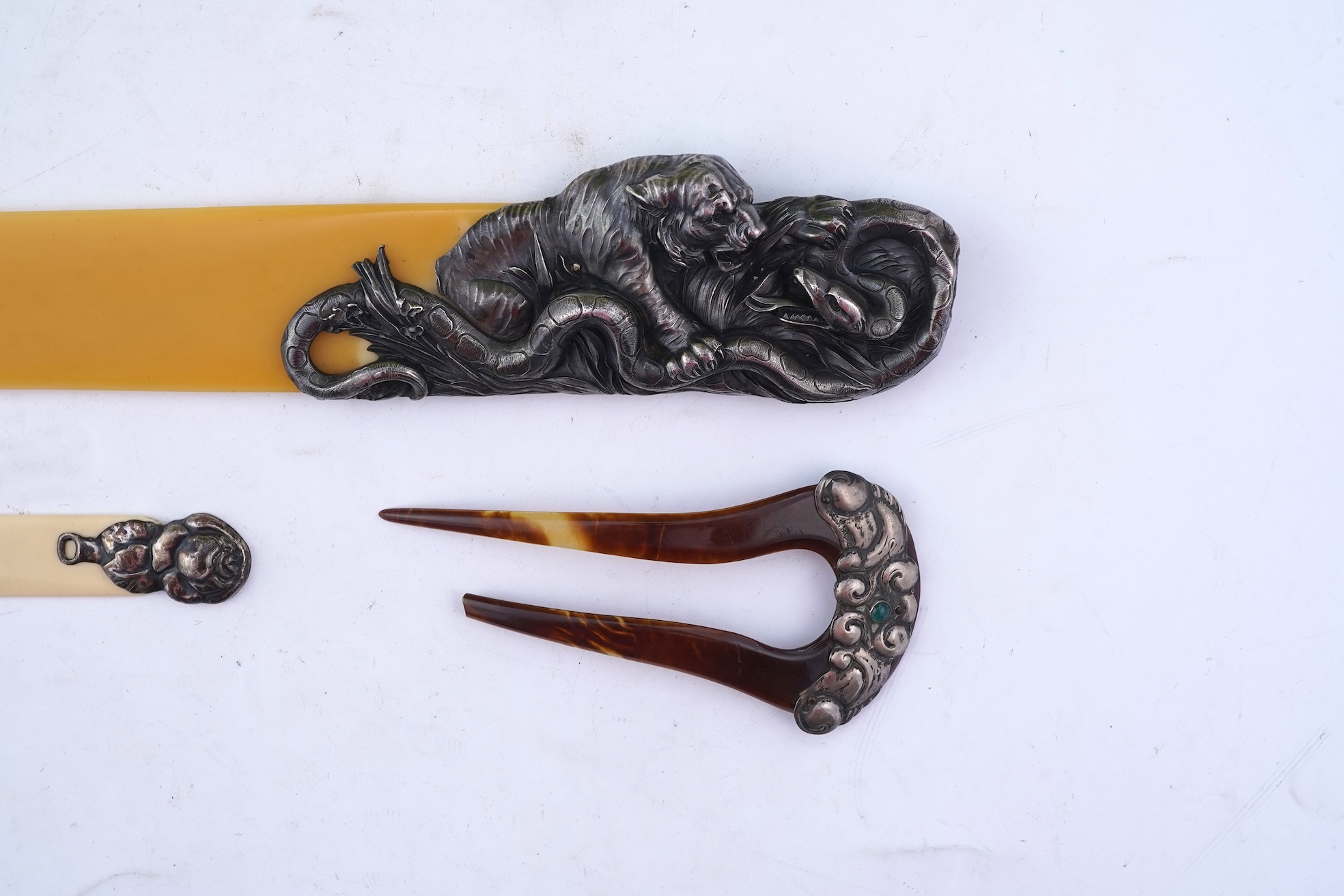Two paper knives and a hair ornament, early 20th century